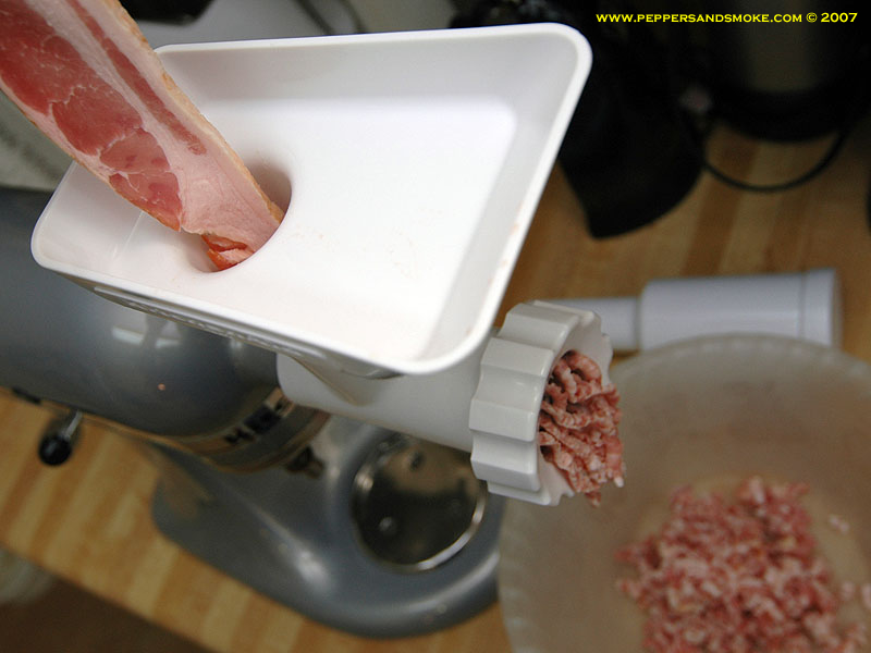 Bacon going through a meat grinder