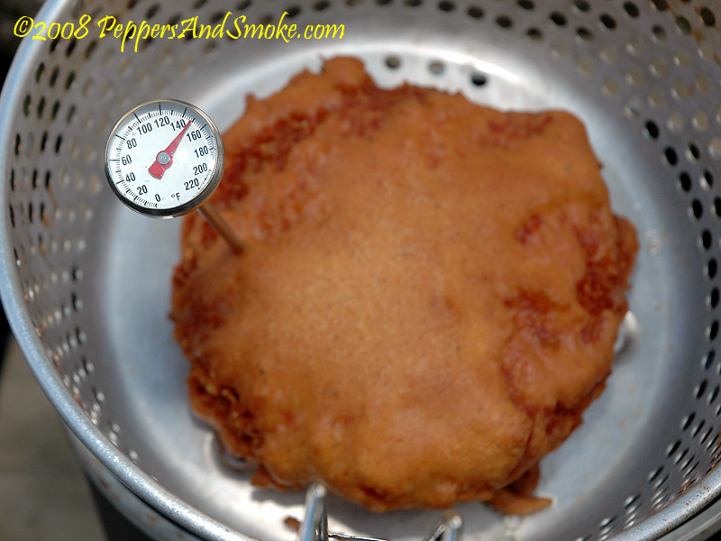 Checking the temperature of the deep fried patty